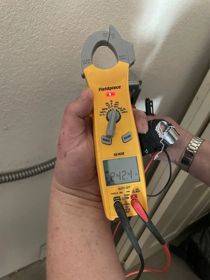 Voltage testing with clamp meter during Outlet Installation in Florida Ridge